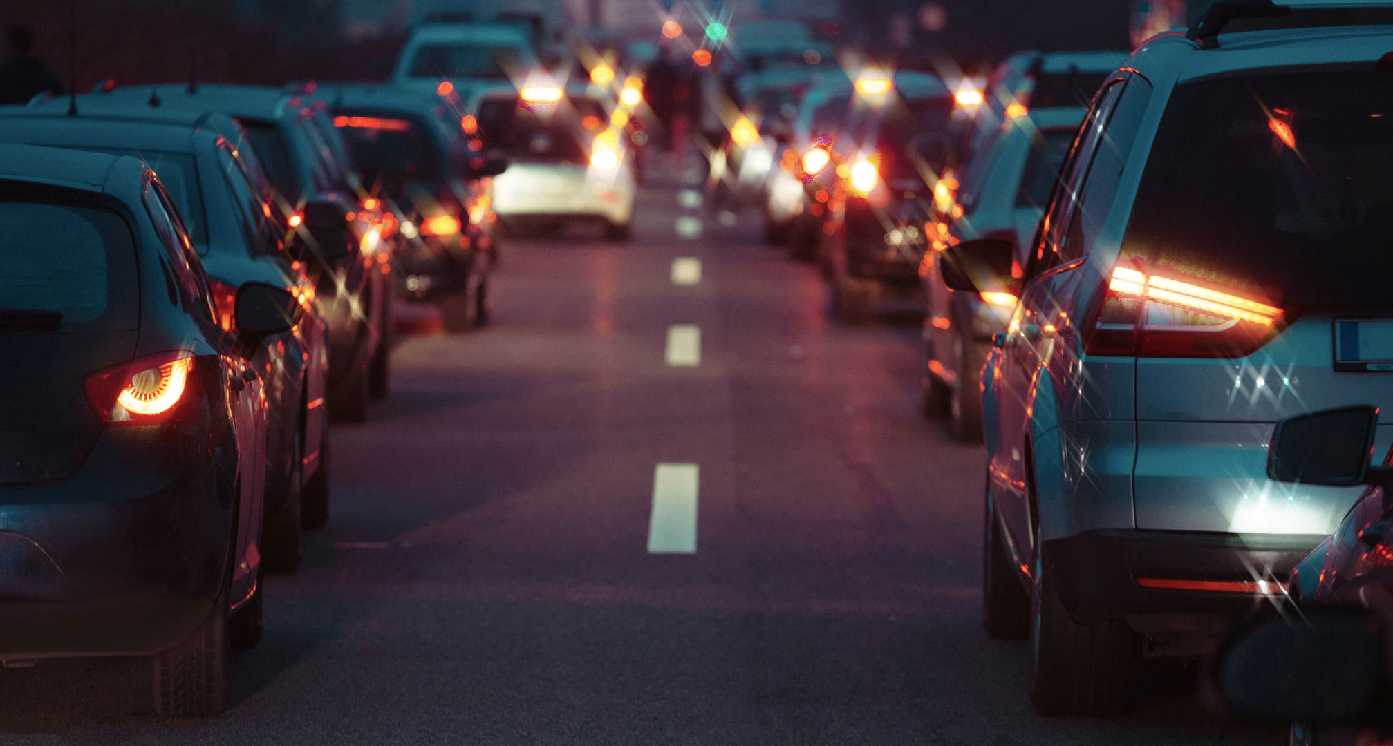 Rays of light running through the centre of car tail lights illustrating astigmatism at night (left). Clear car tail lights at night seen by normal eye (right)