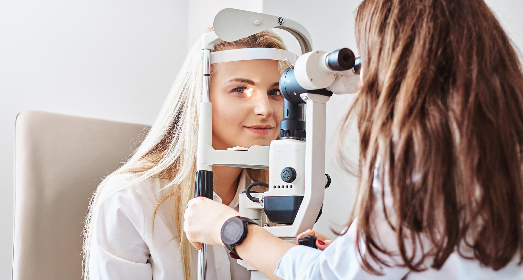 optiker undersöker kvinnans ögon